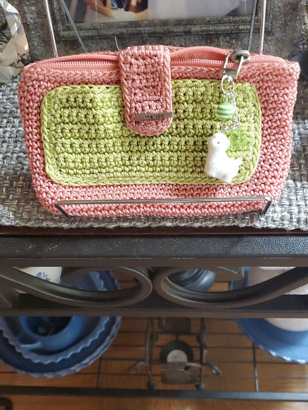 The Sak Crochet Wristlet Clutch in Pink and Green with Charm